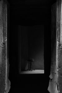 Woman standing by window in building