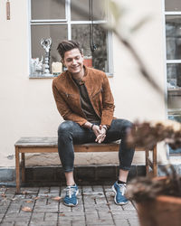 Portrait of young man sitting on seat