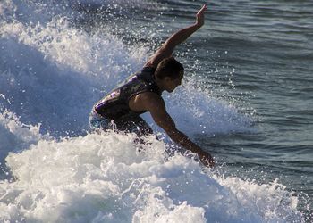 Rear view of girl playing in water