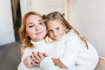 Portrait of mother and daughter at home