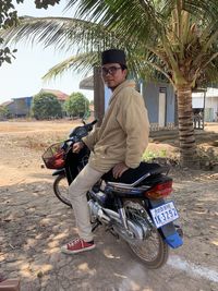 Portrait of man riding motorcycle sitting on road