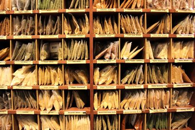 Food packets on wooden shelf at store for sale