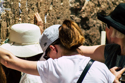 Rear view of man holding hat