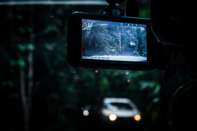 Close-up of reflection of car on side-view mirror