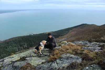 Dog sitting on mountain