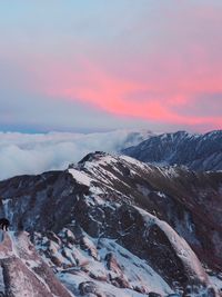 Scenic view of snowcapped mountains against sky during sunset