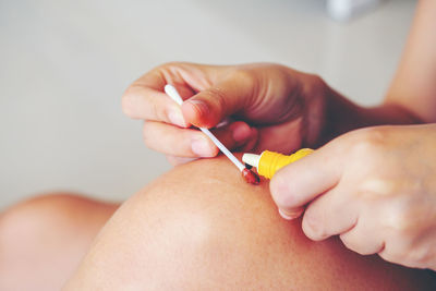 Close-up of woman cleaning wound