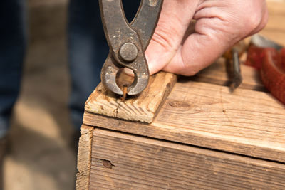 Cropped hand working on wood