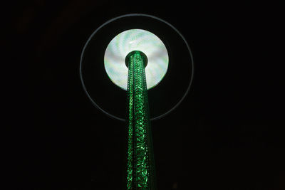 Close-up of illuminated lamp against sky at night