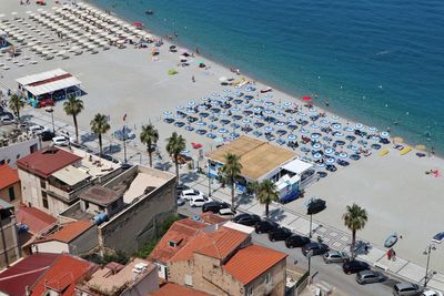 High angle view of buildings by sea in city