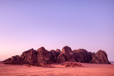 Rock formations on landscape against clear sky