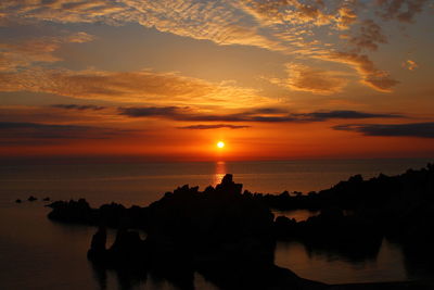 Scenic view of sea against romantic sky at sunset