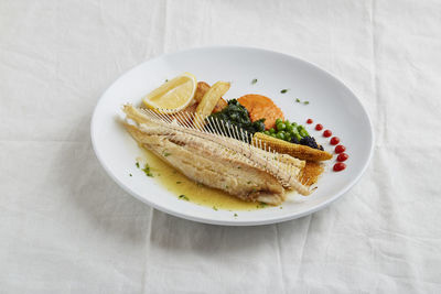 High angle view of fish in plate on table