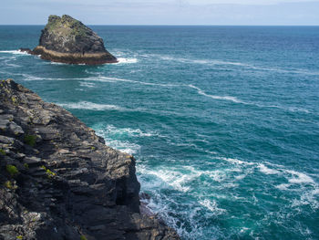 Scenic view of rocks in sea against sky