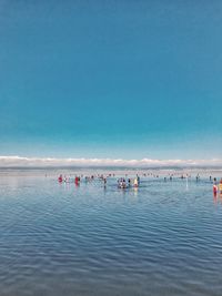 People on beach against sky