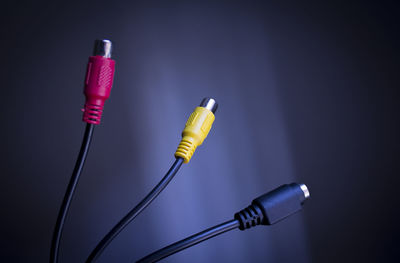 Close-up of electric plugs against black background