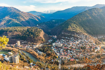 High angle view of townscape and mountains against sky