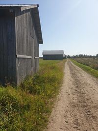 Road amidst buildings against sky