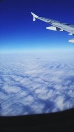 Cropped image of airplane flying over landscape