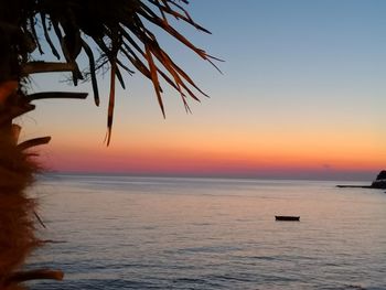 Scenic view of sea against orange sky