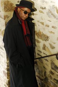 Side view of man standing against wall