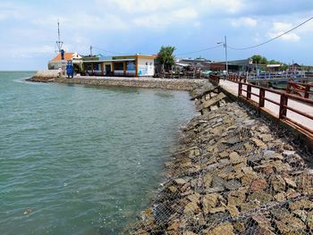 Panoramic view of sea and buildings against sky