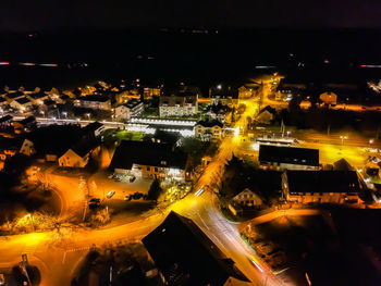 High angle view of illuminated street and buildings at night