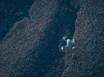 High angle view of drone flying over field