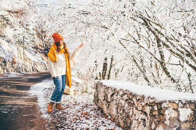 Full length of woman standing on snow