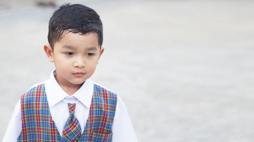 Portrait of boy standing against water