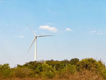 Windmill on field against sky