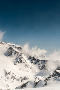 Scenic view of snow covered mountains against sky