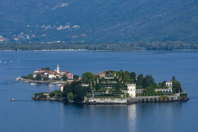 Scenic view of sea by buildings in city