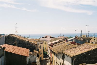 High angle view of buildings by sea against sky