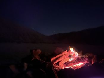 Moon sky, camp fire with flaming hot in the middle of the desert 