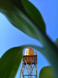 Low angle view of water tower against blue sky