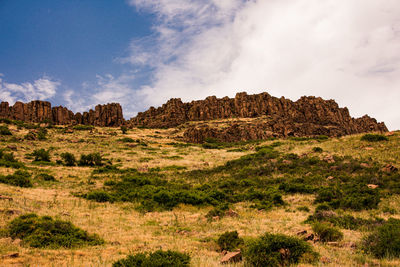 Rock formations on landscape against sky