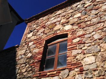 Low angle view of window on wall of building