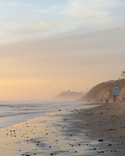 Scenic view of beach against sky during sunset