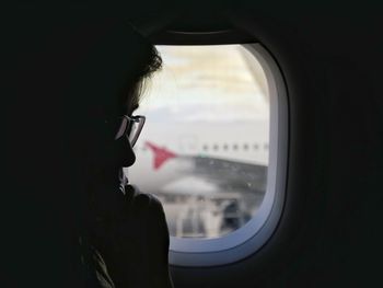 Man looking through airplane window