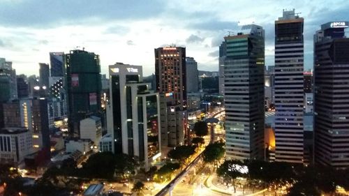 Illuminated cityscape against sky at night