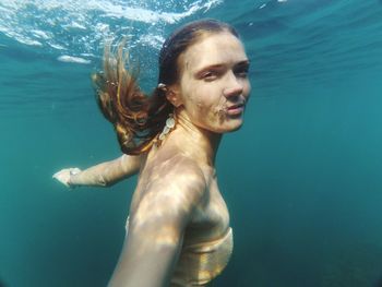 Portrait of woman swimming in sea