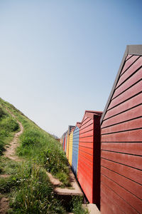 View of footpath amidst buildings against clear sky