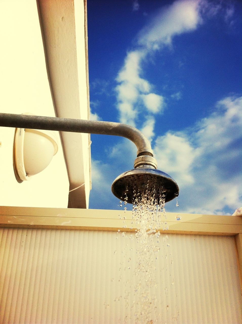 low angle view, architecture, built structure, sky, building exterior, lighting equipment, cloud - sky, day, no people, indoors, hanging, cloud, blue, window, metal, modern, sunlight, directly below, glass - material