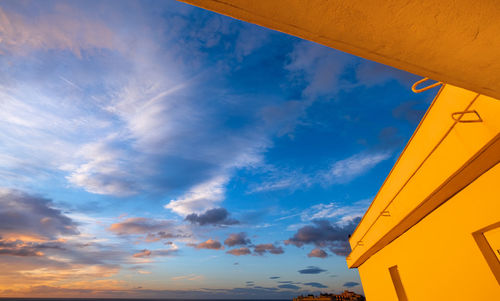 Low angle view of building against sky during sunset