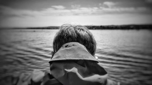 Rear view of woman looking at sea against sky