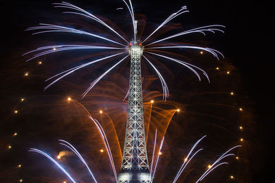 Low angle view of firework display at night