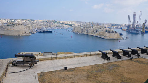 High angle view of buildings by sea against sky