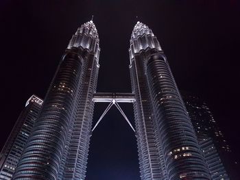 Low angle view of illuminated skyscrapers against sky at night