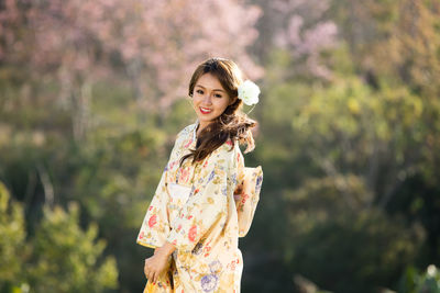 Portrait of a smiling young woman standing outdoors